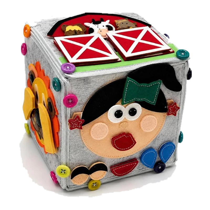 Dado Sensorial Montessori ImaginJoy: cubo de actividades con una granja con puertas, una cara con lazo verde y un león en sus caras
